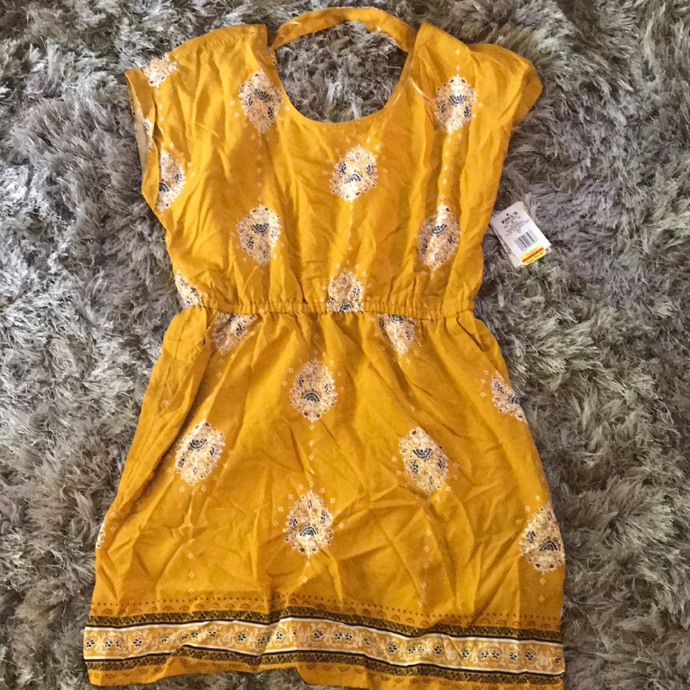 Yellow open back mini dress.
